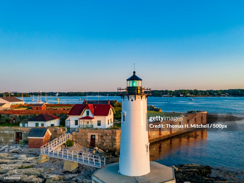 High angle view of lighthouse by sea against clear blue sky,United States,USA