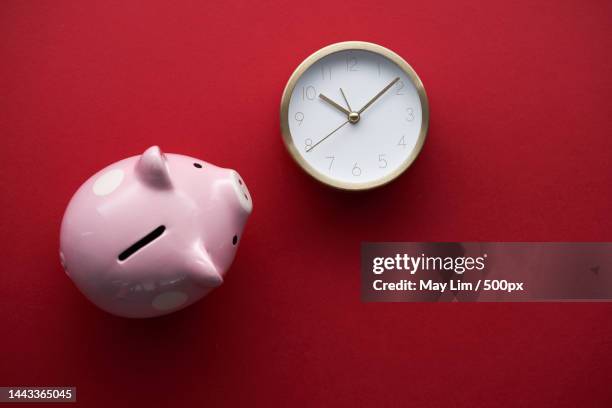 top view of piggy bank and alarm clock,malaysia - time is money stock pictures, royalty-free photos & images