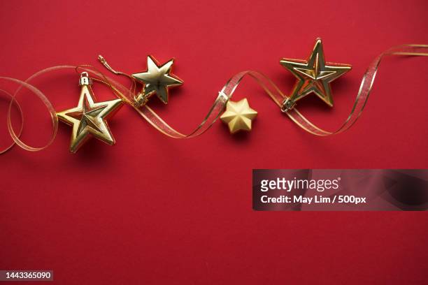 star shape christmas ornament against red background,malaysia - herrnhuter stern stock-fotos und bilder