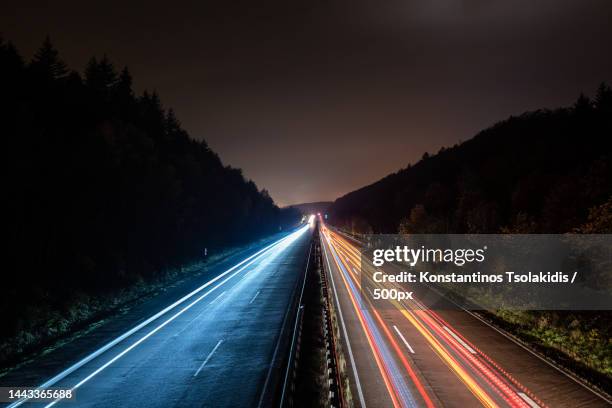 high angle view of light trails on highway at night,kaiserslautern,germany - high performance stockfoto's en -beelden