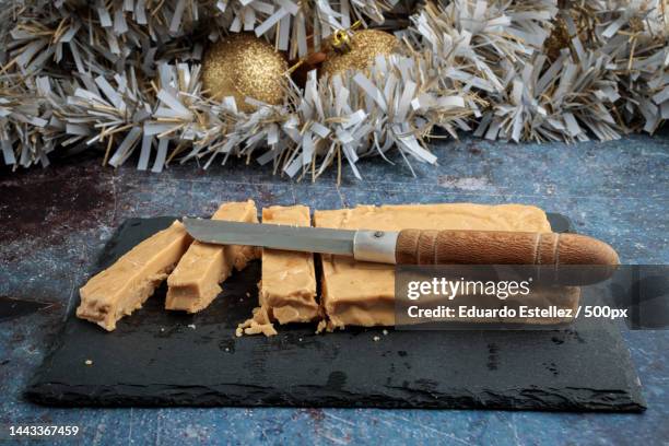 high angle view of cinnamon sticks on table,spain - nougat stock-fotos und bilder