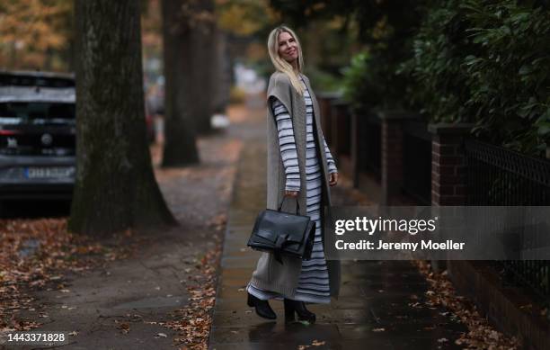 Vanessa Giers seen wearing SoSUE Laura black and white knit dress ,SoSUE Knit Cosy Azteco beige vest, Naditum black leather handbag, & other stories...