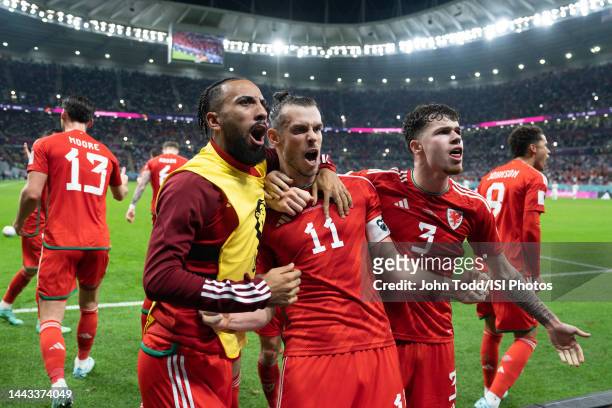 Sorba Thomas of Wales, Christian Bale of Wales, and Neco Williams of Wales celebrates Bales' penalty-kick goal during a FIFA World Cup Qatar 2022...