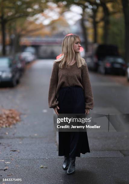 Tabea seen wearing SoSUE Satin long black navy skirt, SoSUE warm brown Polo Hana , SoSUE Blouson Knit Navy black and white, Zara black shiny leather...