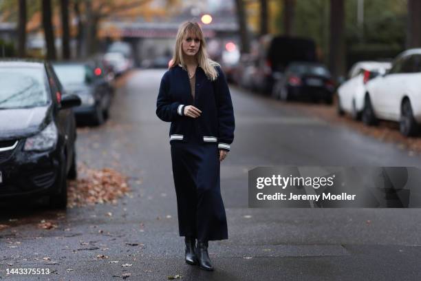 Tabea seen wearing SoSUE Satin long black navy skirt, SoSUE warm brown Polo Hana , SoSUE Blouson Knit Navy black and white, Zara black shiny leather...