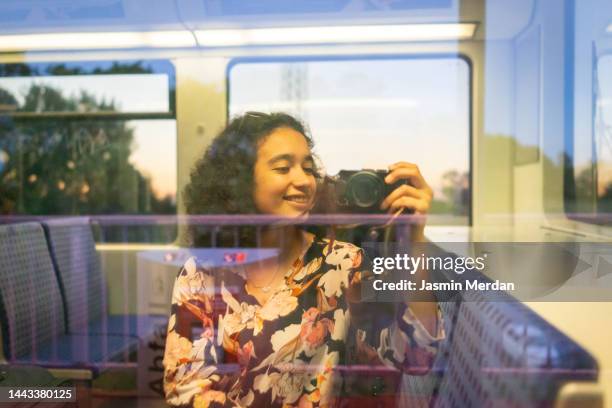 woman taking a picture of herself in a bus - study abroad stock pictures, royalty-free photos & images