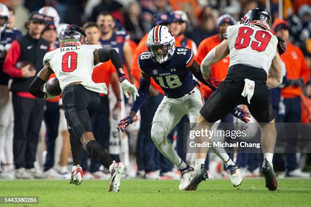 Cornerback Nehemiah Pritchett of the Auburn Tigers looks to tackle wide receiver Jaylen Hall of the Western Kentucky Hilltoppers at Jordan-Hare...