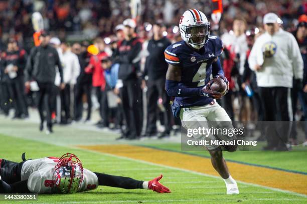 Cornerback D.J. James of the Auburn Tigers runs the ball by tight end Joshua Simon of the Western Kentucky Hilltoppers during the second half of play...