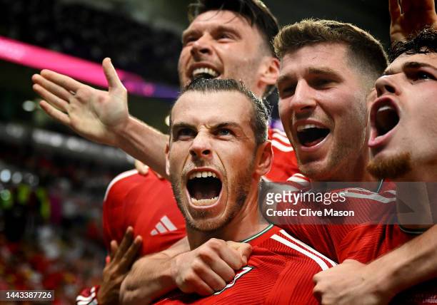 Gareth Bale of Wales celebrates with teammates after scoring their team's first goal via a penalty past Matt Turner of United States during the FIFA...