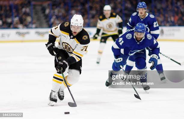 Taylor Hall of the Boston Bruins looks to pass during a game against the Tampa Bay Lightning at Amalie Arena on November 21, 2022 in Tampa, Florida.