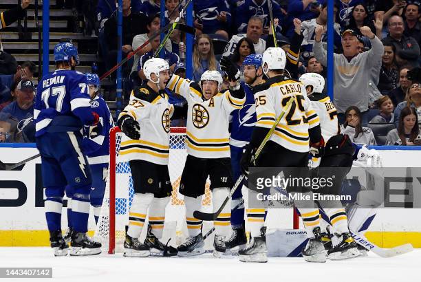 Patrice Bergeron of the Boston Bruins celebrates his 1000th goal during a game against the Tampa Bay Lightning at Amalie Arena on November 21, 2022...