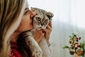blond woman kissing holding her cat