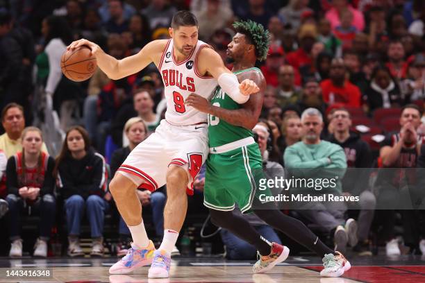 Nikola Vucevic of the Chicago Bulls drives to the basket against Marcus Smart of the Boston Celtics during the first half at United Center on...