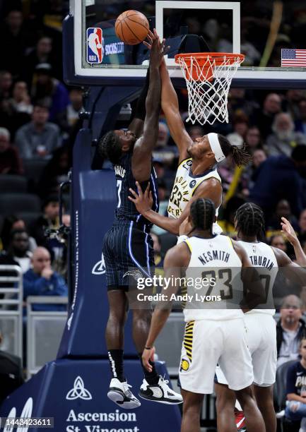 Myles Turner of the Indiana Pacers blocks the shot of Kevon Harris of the Orlando Magic at Gainbridge Fieldhouse on November 21, 2022 in...