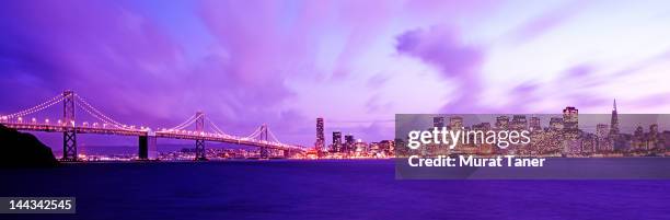 oakland bay bridge and san francisco skyline - oakland california skyline stock pictures, royalty-free photos & images