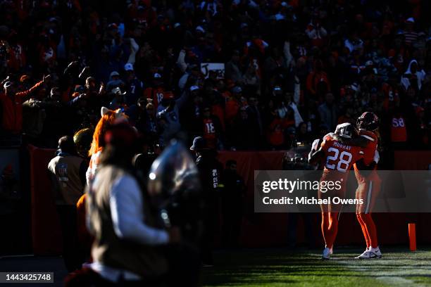 Latavius Murray of the Denver Broncos celebrates with his teammate Eric Tomlinson after running for a touchdown during an NFL game between the Las...