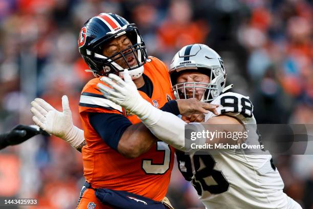 Russell Wilson of the Denver Broncos is hit by Maxx Crosby of the Las Vegas Raiders during an NFL game between the Las Vegas Raiders and Denver...