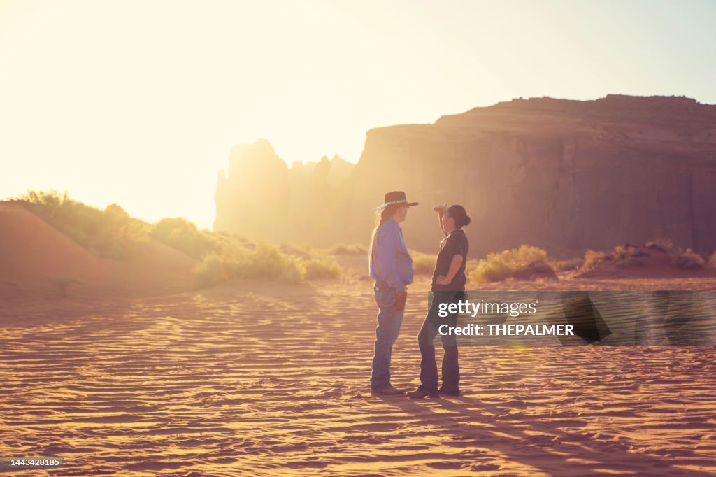 Navajo man and his wife on the sand dunes in Monument Valley - Utah