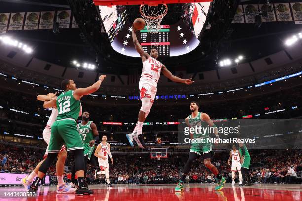 Ayo Dosunmu of the Chicago Bulls dunks the ball against the Boston Celtics during the second half at United Center on November 21, 2022 in Chicago,...
