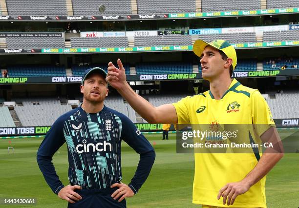 Pat Cummins of Australia and Jos Buttler of England take part in the coin toss prior to game three of the One Day International series between...