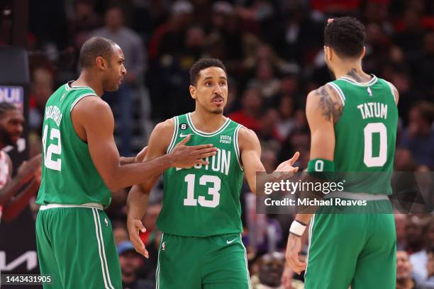 Malcolm Brogdon of the Boston Celtics celebrates with Al Horford and Jayson Tatum against the Chicago Bulls during the second half at United Center...