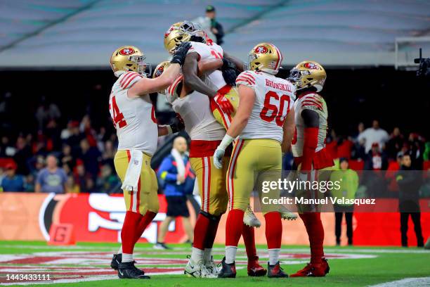 Brandon Aiyuk of the San Francisco 49ers celebrates with teammates after scoring a touchdown against the Arizona Cardinals during the third quarter...