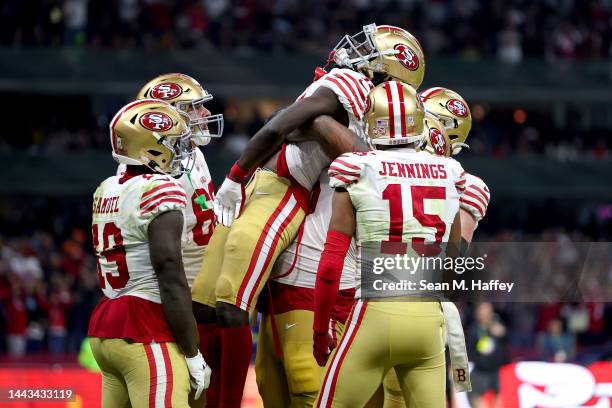 Brandon Aiyuk of the San Francisco 49ers celebrates with teammates after scoring a touchdown against the Arizona Cardinals during the third quarter...