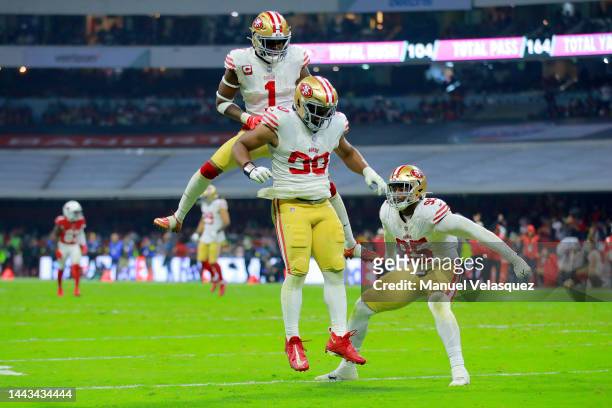 Kevin Givens of the San Francisco 49ers celebrates with teammates Jimmie Ward and Drake Jackson of the San Francisco 49ers after a sack against the...