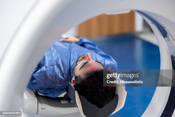 patient getting a cat scan at the hospital - pet scan stock pictures, royalty-free photos & images