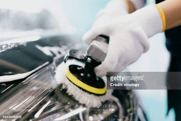 workers are polishing car lights in factory - auto detailing stock pictures, royalty-free photos & images