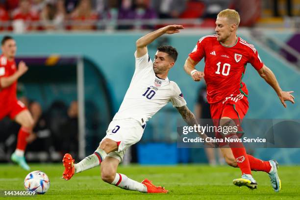 Christian Pulisic of United States and Aaron Ramsey of Wales compete for the ball during the FIFA World Cup Qatar 2022 Group B match between USA and...