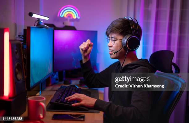 gamer is using keyboard and mouse and wearing a headset. - game streamer stock pictures, royalty-free photos & images