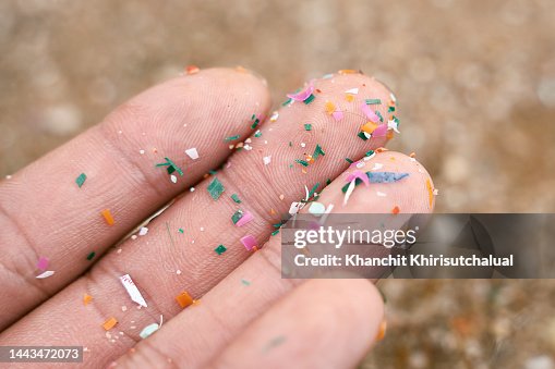 Close up side shot of microplastics lay on people hand. Concept of water pollution and global warming. Climate change idea. micro plastics concept in food and water or sea Close up side shot of microplastics lay on people hand. Concept of water pollution and global warming. Climate change idea. micro plastics concept in food and water or sea