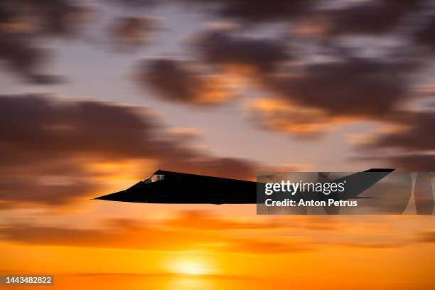 tactical stealth attack aircraft at sunset - aerial surveillance stock pictures, royalty-free photos & images