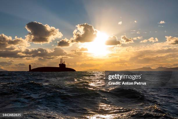 nuclear submarine at sea at sunset. submarine fleet - sub stock pictures, royalty-free photos & images