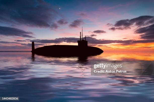 nuclear submarine at sea at sunset. submarine fleet - submarine stock pictures, royalty-free photos & images