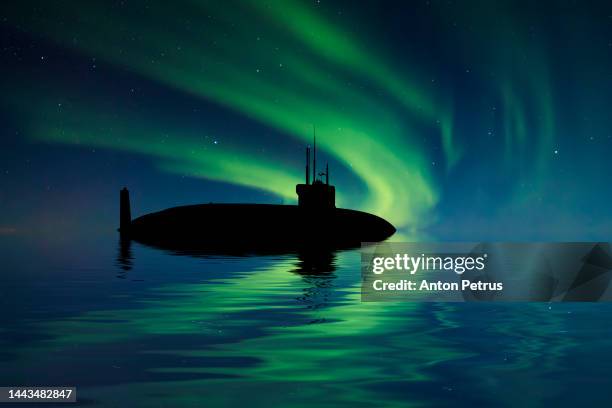 nuclear submarine at sea at under the northern lights. submarine fleet - military submarine stock pictures, royalty-free photos & images