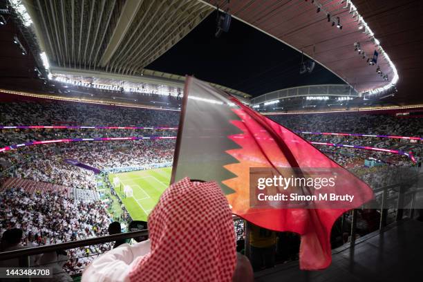 Spectator with a Qatari flag during the opening game of the World Cup between Qatar and Ecuador at the Al Bayt Stadium on November 20th, 2022 in Al...