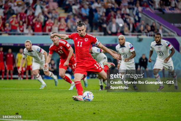 Gareth Bale of Wales scores his team's first goal with a penalty during the FIFA World Cup Qatar 2022 Group B match between USA and Wales at Ahmad...