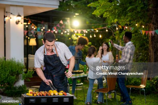 barbecue party backyard - asian person bbq stock-fotos und bilder