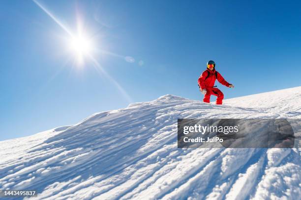 young adult man snowboarding in mountains at ski resort - ski wear stock pictures, royalty-free photos & images