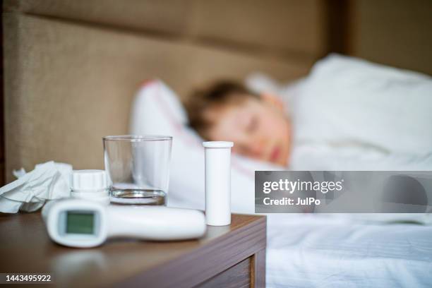 school age boy laying in bed with a flu - boy asleep in bed bildbanksfoton och bilder