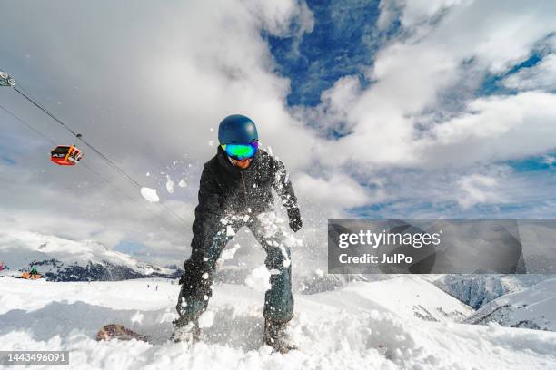 young adult man jumping on snowboard in mountains - snowboard jump close up stock pictures, royalty-free photos & images
