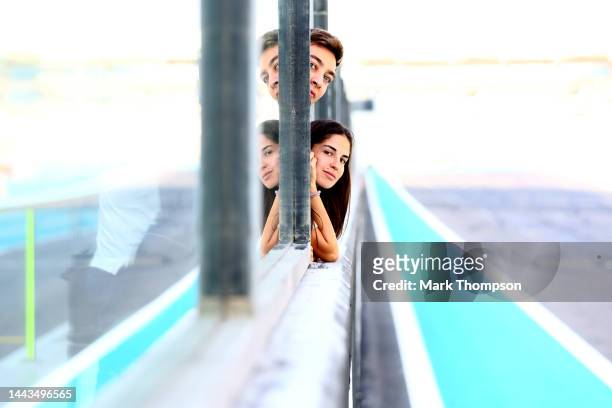 George Russell of Great Britain and Mercedes and Carmen Montero Mundt look on from the pitwall during Formula 1 testing at Yas Marina Circuit on...