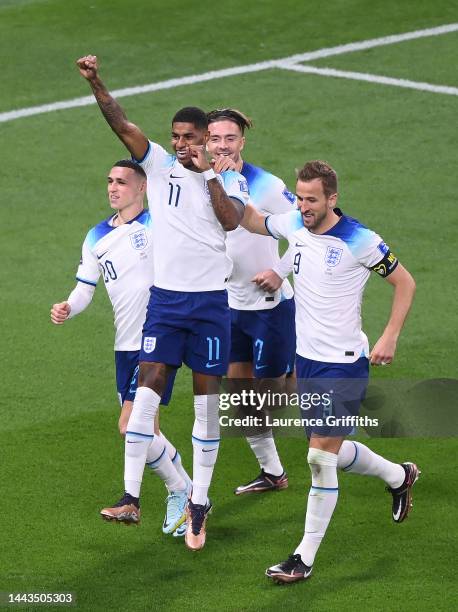 Marcus Rashford celebrates with Phil Foden, Jack Grealish and Harry Kane after scoring their team's fifth goal during the FIFA World Cup Qatar 2022...