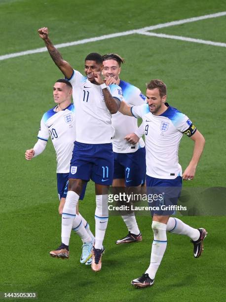 Marcus Rashford celebrates with Phil Foden, Jack Grealish and Harry Kane after scoring their team's fifth goal during the FIFA World Cup Qatar 2022...