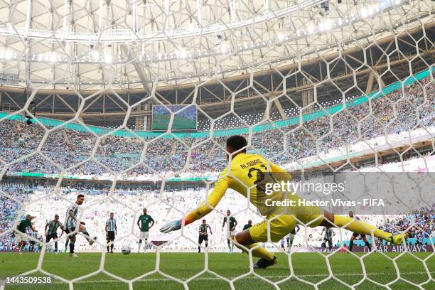 Lionel Messi of Argentina scores their team's first goal via a penalty past Mohammed Al-Owais of Saudi Arabia during the FIFA World Cup Qatar 2022...