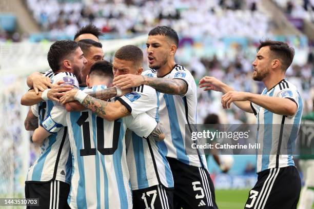 Lionel Messi of Argentina celebrates with teammates after scoring their team's first goal from the penalty spot during the FIFA World Cup Qatar 2022...