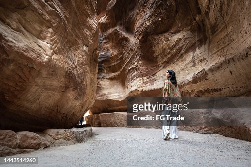 Mid adult woman tourist walking and admiring Petra, Jordan