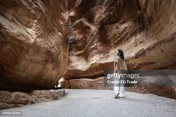 mid adult woman tourist walking and admiring petra, jordan - explorer imagens e fotografias de stock